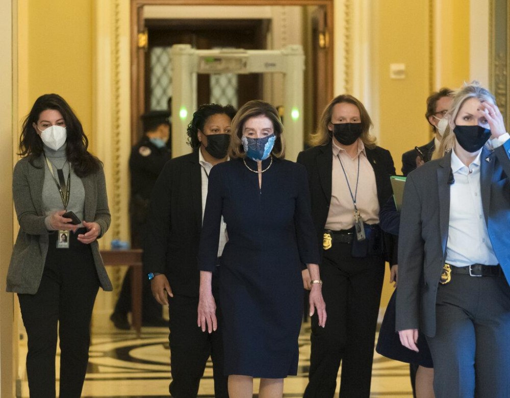 Speaker of the House Nancy Pelosi, D-Calif., returns to her leadership office after opening debate on the impeachment of President Donald Trump, at the Capitol in Washington, Wednesday, Jan. 13, 2021. (AP Photo / J. Scott Applewhite)